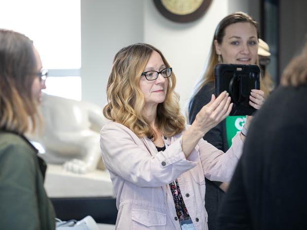 Individual holds tablet during augmented reality workshop