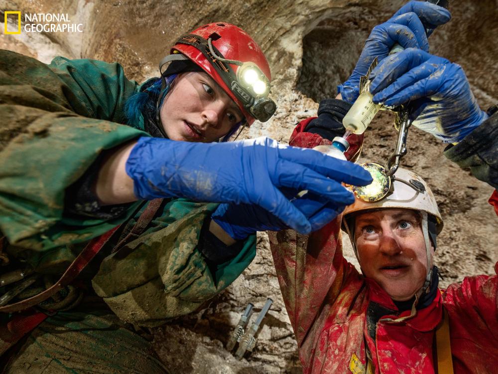 Scientists look at biofilm sample in cave