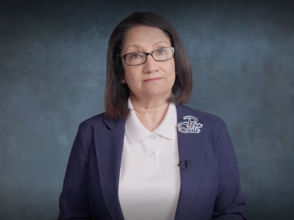 A headshot of Penn State President Neeli Bendapudi wearing a blue jacket and white shirt