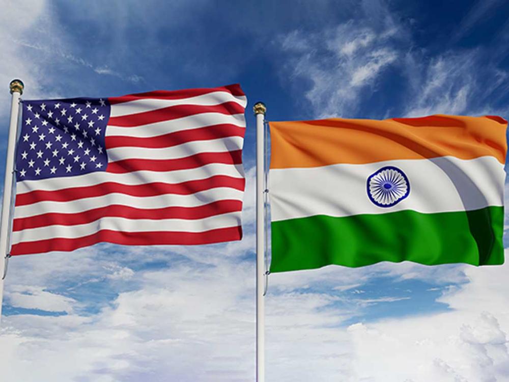 U.S. flag and Indian flag wave on flag poles next to each other