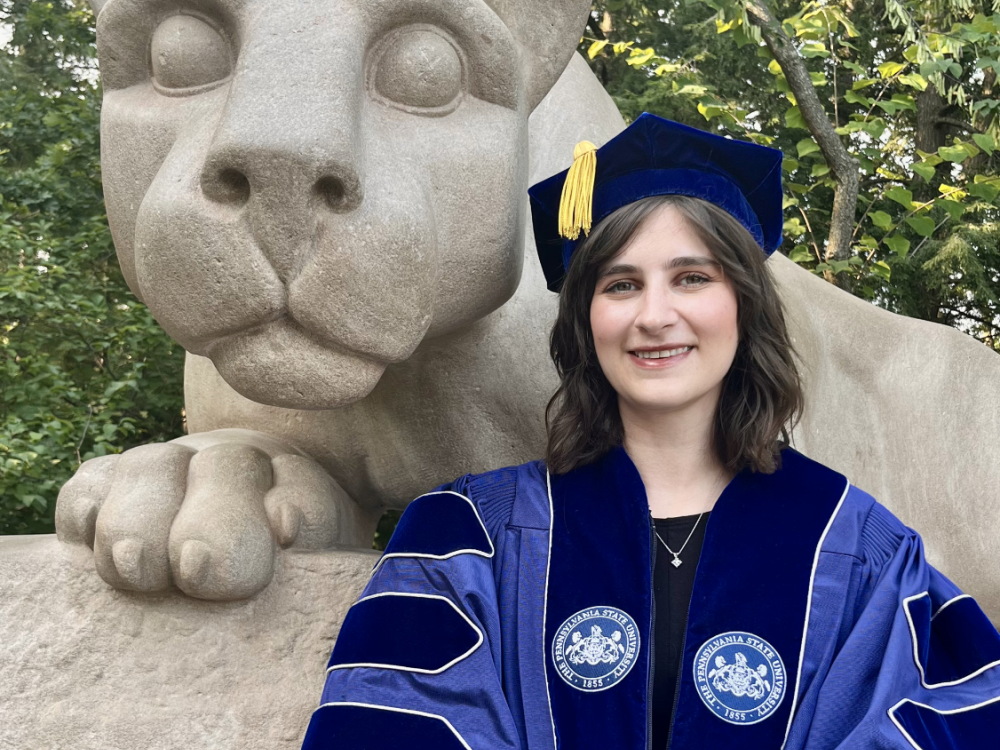 Headshot of Hannah standing in front of Nittany Lion statue 