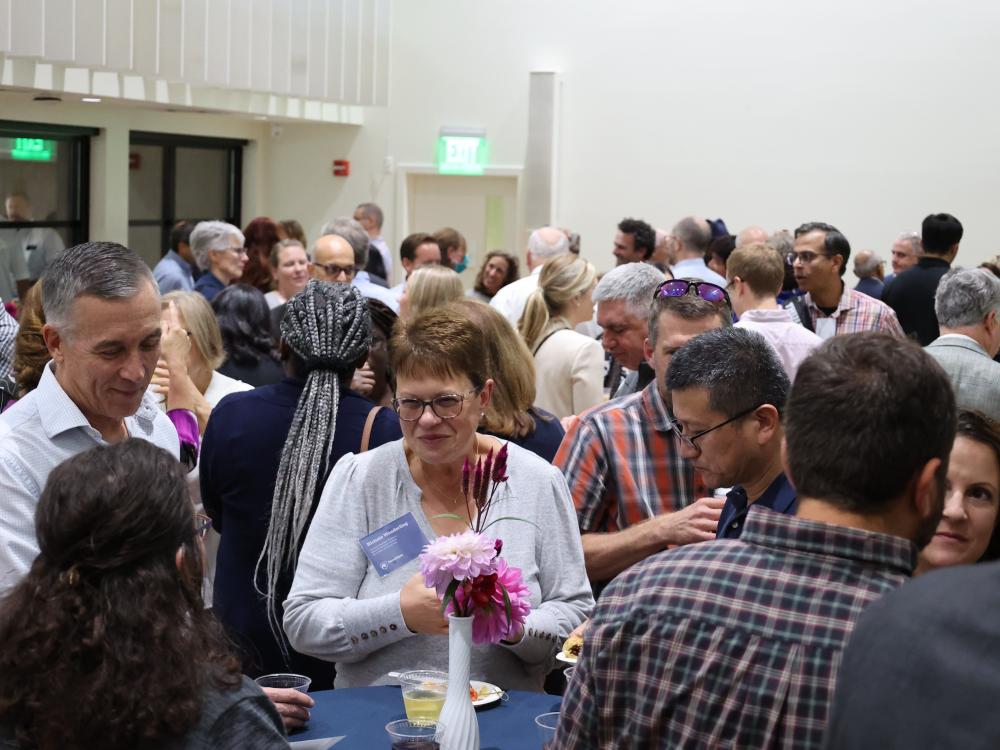 Faculty and families enjoying conversation at public event