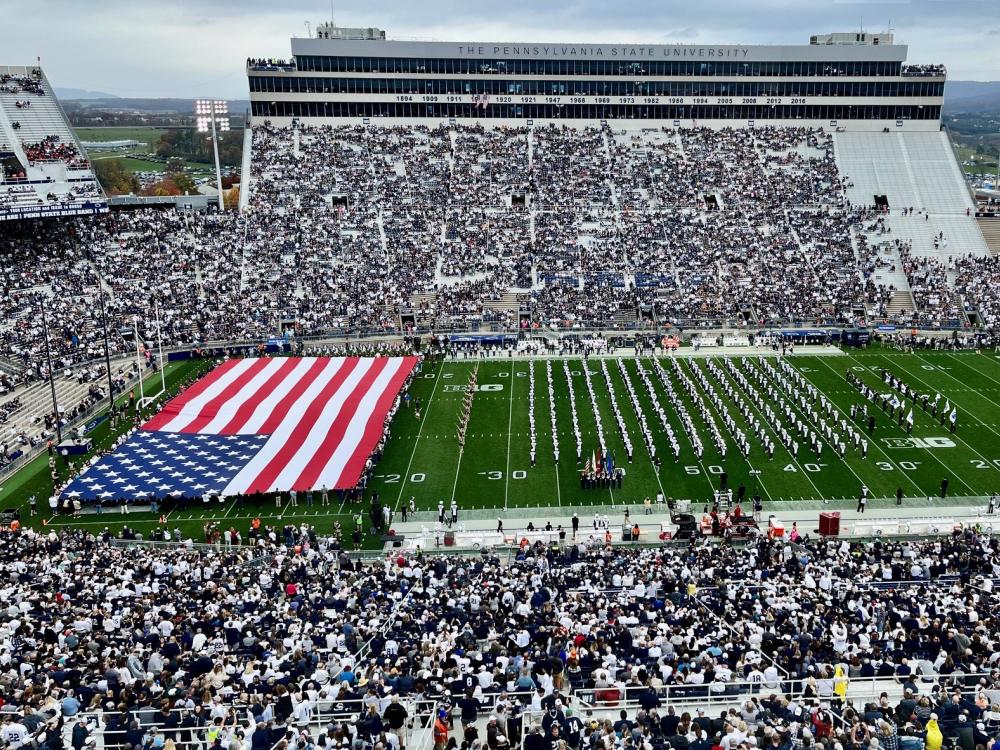 Beaver Stadium with a large US flag covering the north endzone