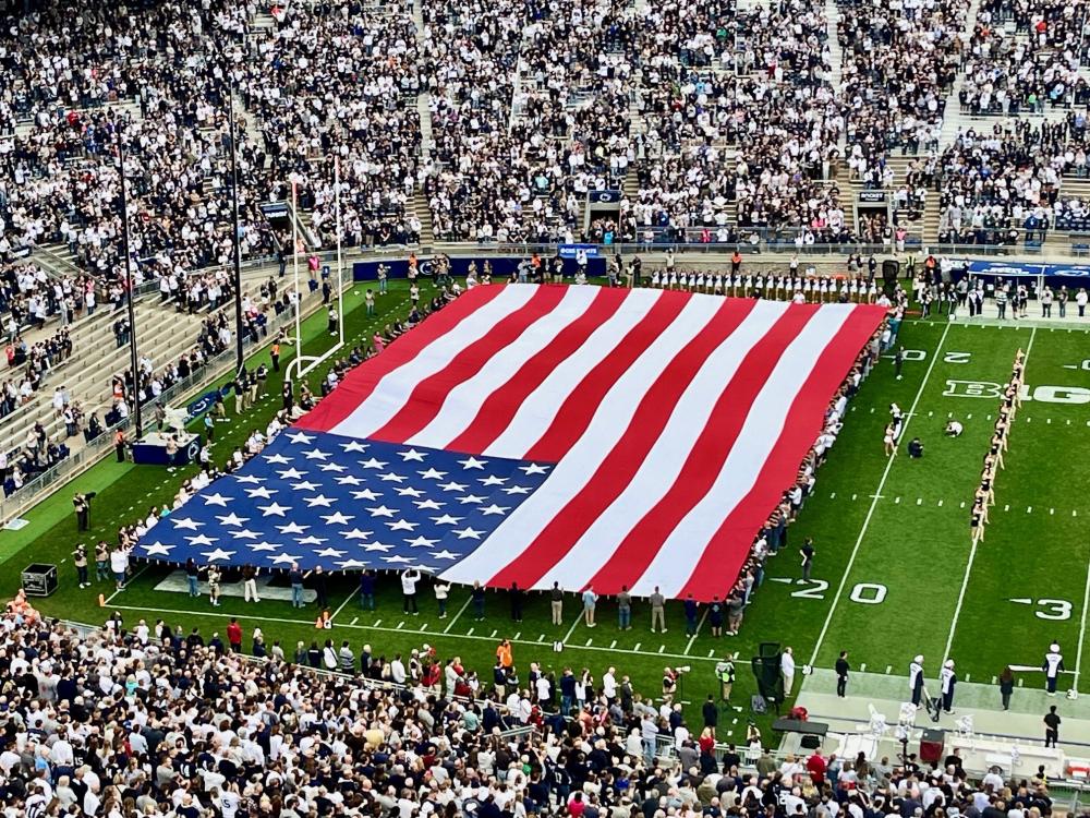 A closeup of the large American flag on the field at Beaver Stadium