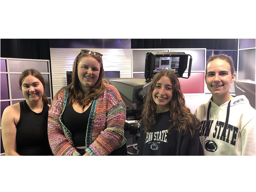 Four girls smiling at camera