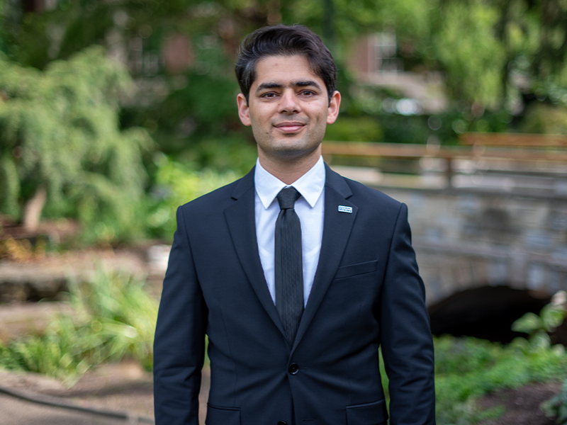 Younes Shekarian standing in garden smiling