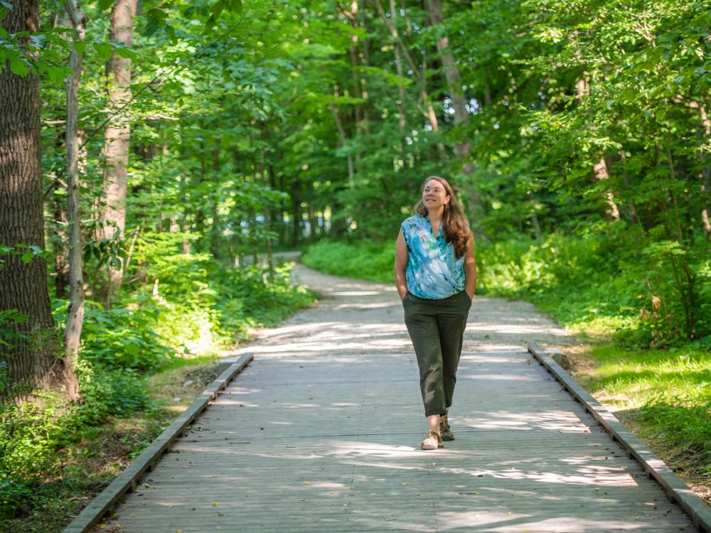 Sherri "Sam" Mason walks on a path through trees