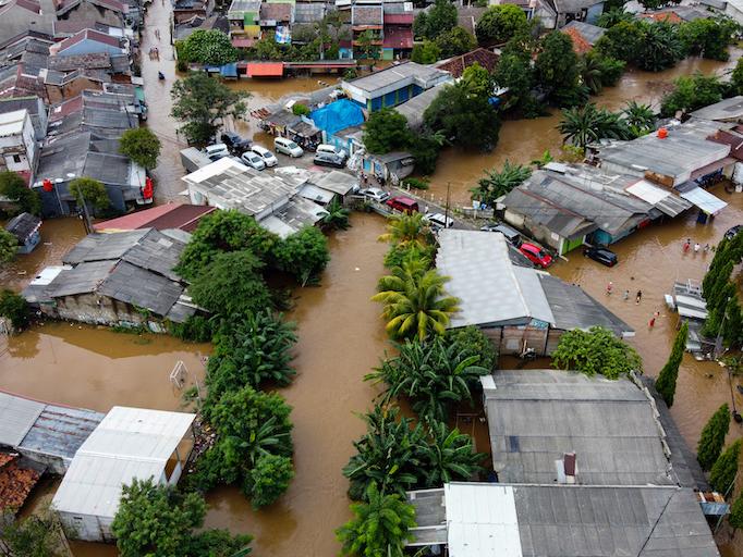 Aerial view of flooding and devastation wrought after massive natural disasters.