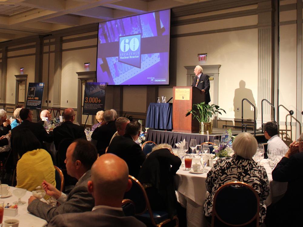 An individual stands at a podium