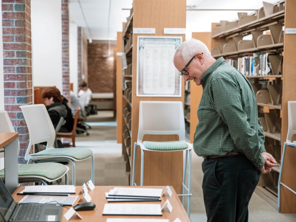 Professor looks at papers on table