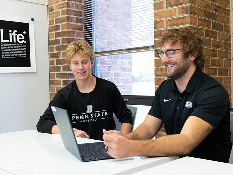 Frankie meets with a student in the library