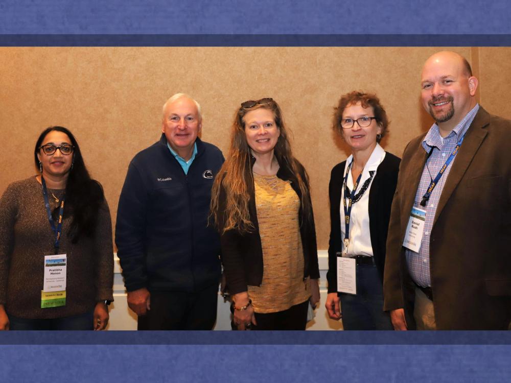 group of professors posing for photo at conference