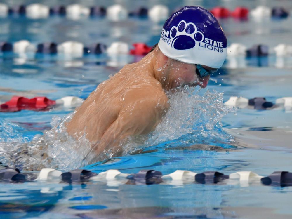 A Penn State Behrend swimmer competes in a breaststroke race.