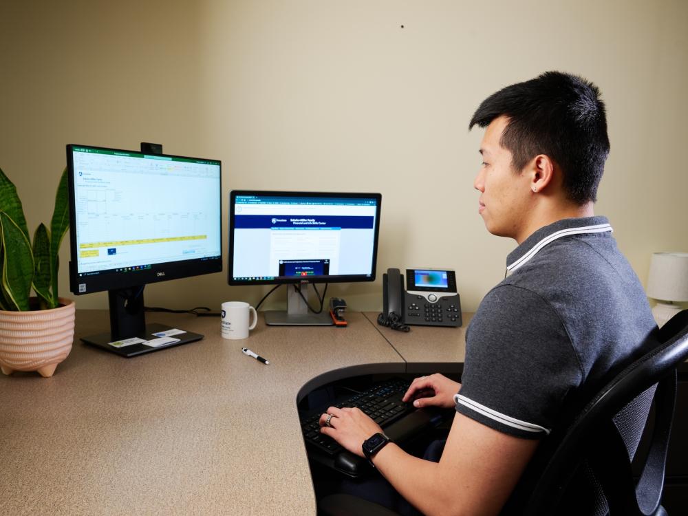 Man sitting in front of computer attending a webinar