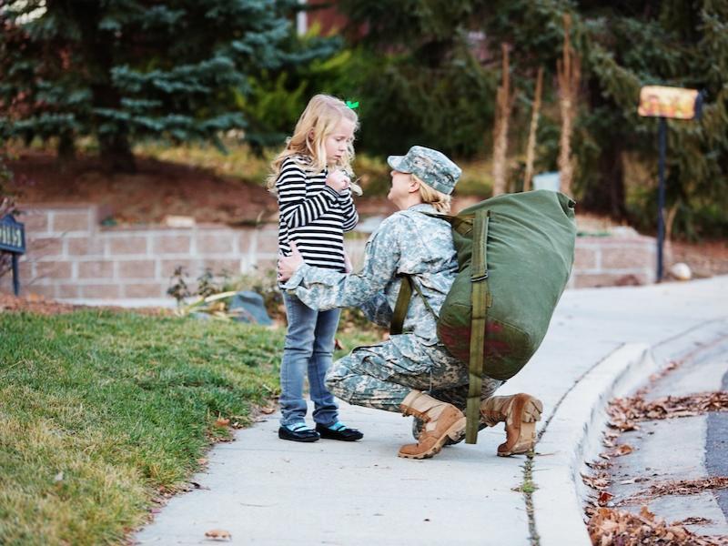 Military mother and daughter greeting each other