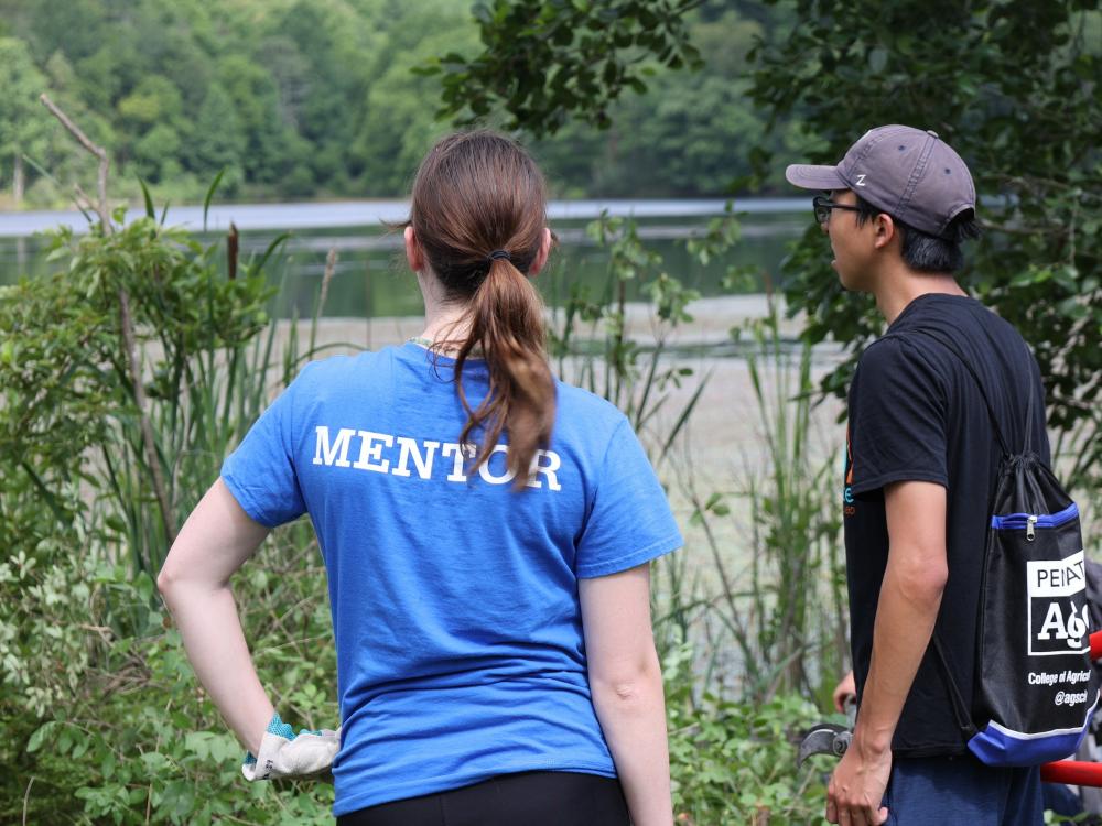 LEAP mentor and student standing together looking at Lake Perez