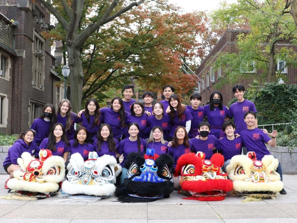 Group of students in purple shirts smiling