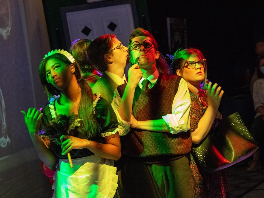 Characters huddle together in a scene from Penn State Harrisburg's fall play, "Clue."