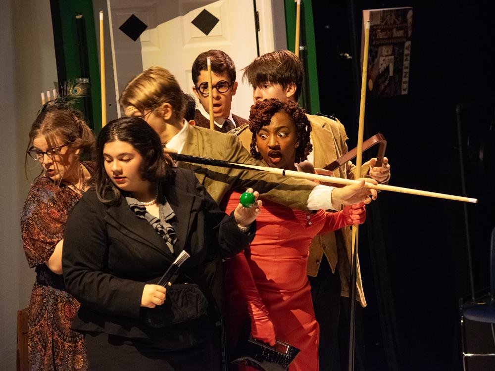 Six characters huddle together in a scene from Penn State Harrisburg's production of "Clue"