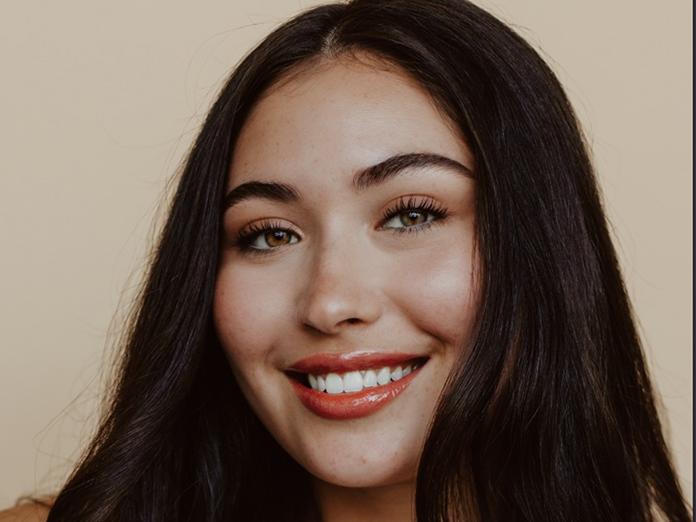 Young woman with dark hair smiling