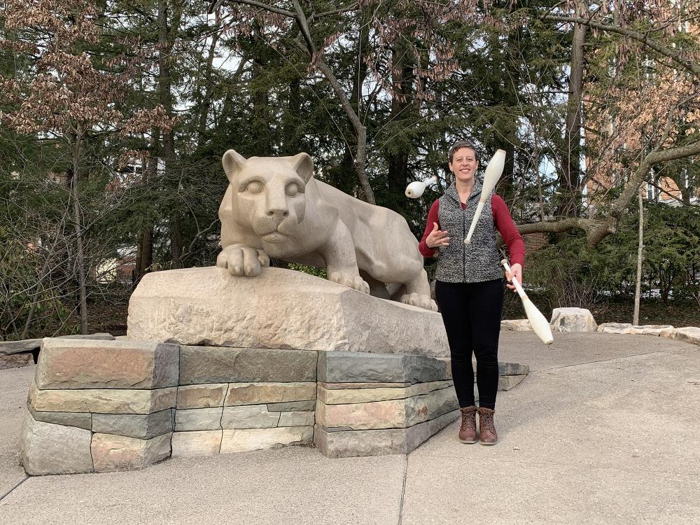 Jen Agans juggling next to the Lion Shrine