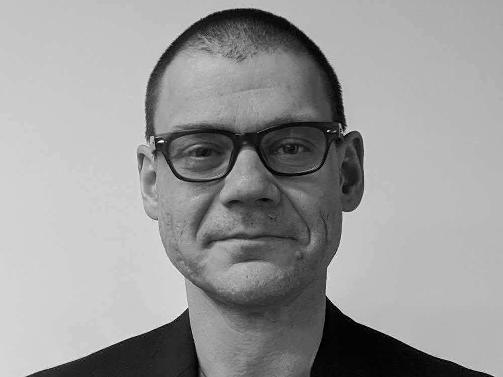 black and white headshot photo of Anton Nekrutenko