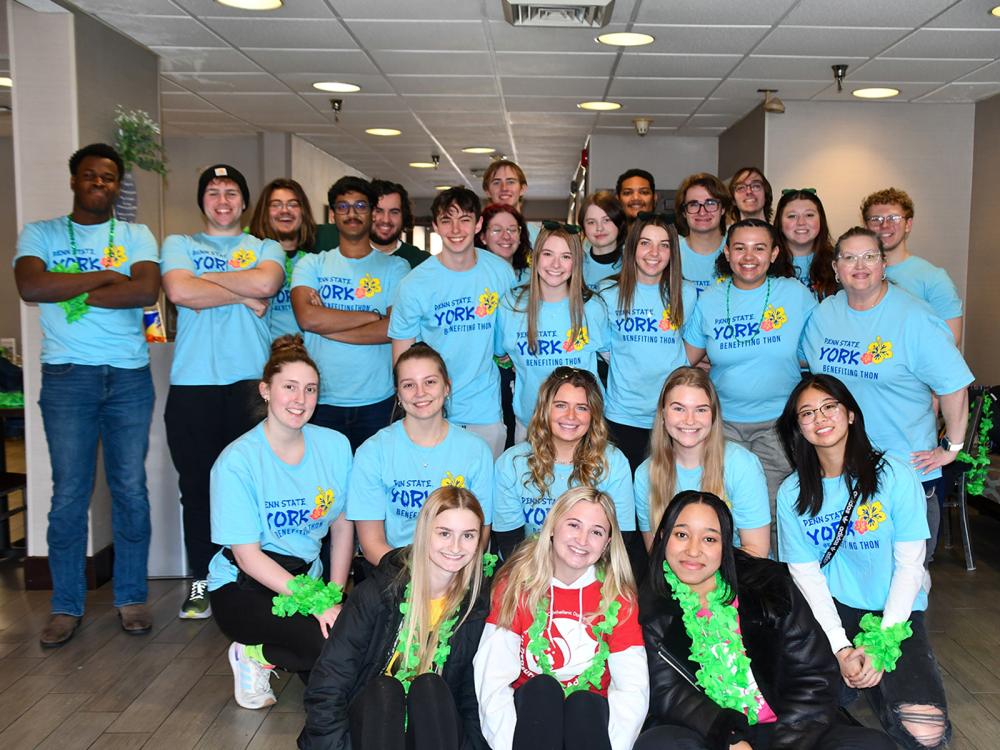 A diverse group of students in light blue shirts for THON