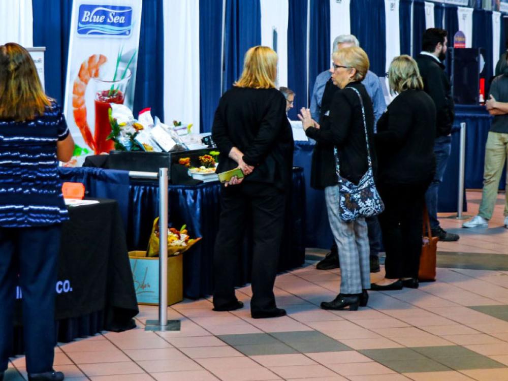 Shoppers and suppliers interacting at the Bryce Jordan Center