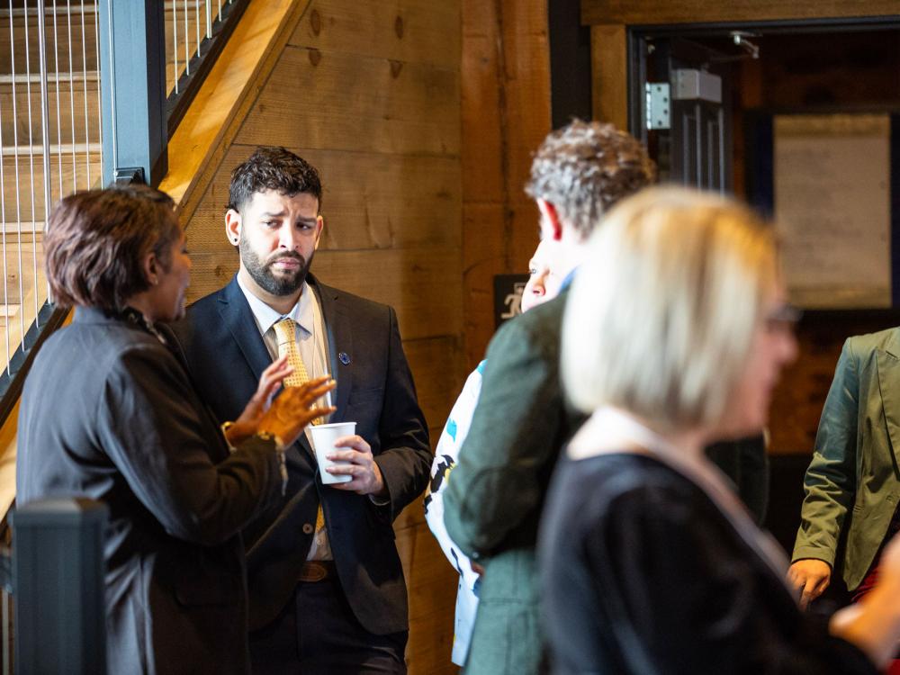 Steven Negron-Candelario, CTSI's ASAP project manager, speaks with other CTSI staff.