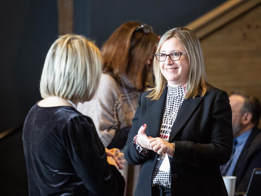 Jess Petrie, CTSI's Education Project Manager, speaks with other CTSI staff.
