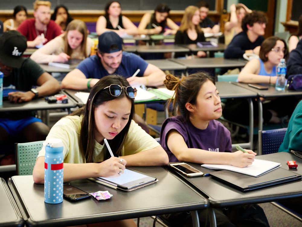 Students sitting at rows of desks attending a guided study group