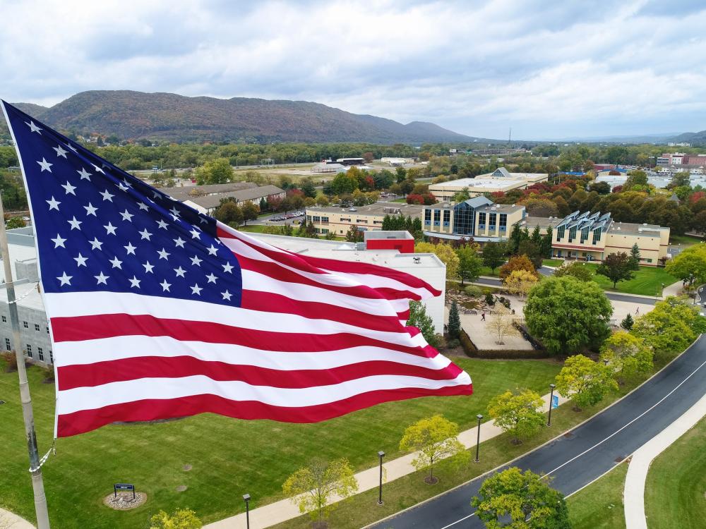 A large American flagging flying above the Penn College campus in Williamsport.