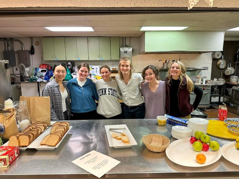 A few members of the Culinary Medicine club are pictured in the kitchen of their soup kitchen event. 