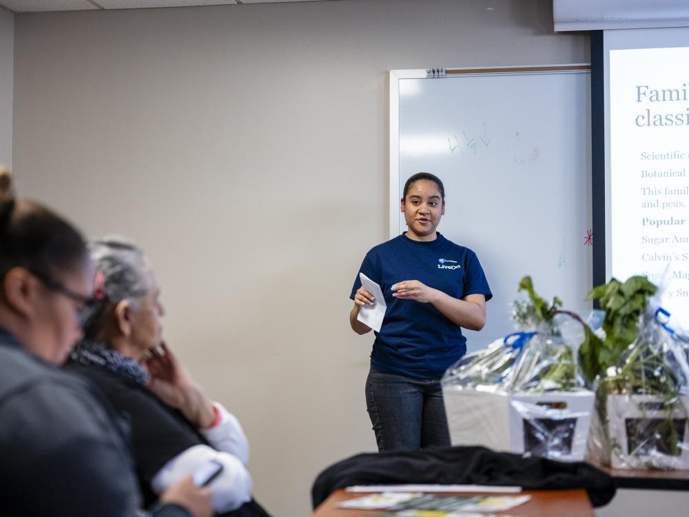 Student presents vegetable research to community members