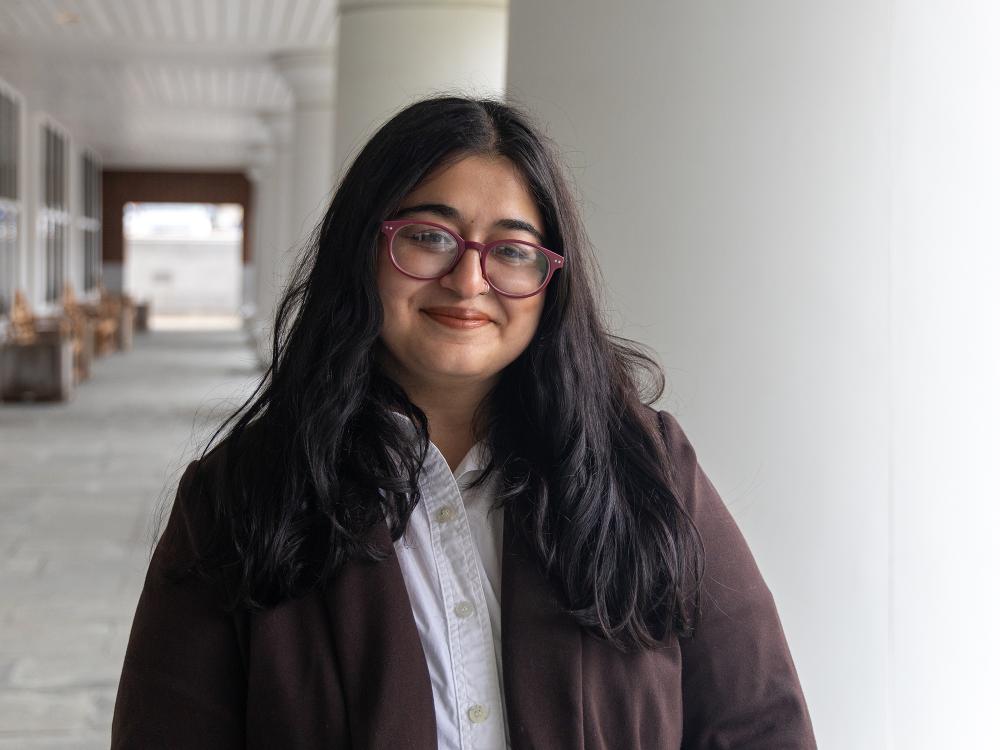 Amanda Mohamed stands outside the Hintz Family Alumni Center.