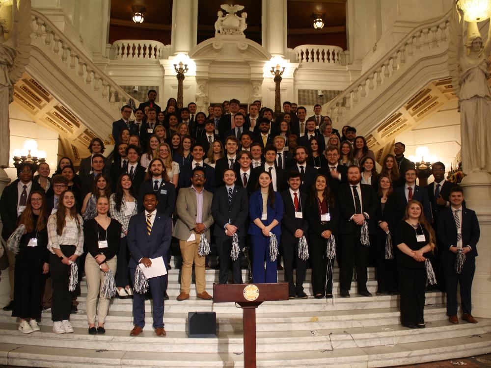 large group of students standing on the steps in state Capitol building in Harrisburg.