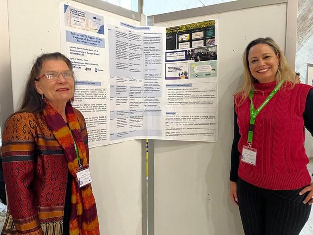 Two women giving a poster presentation