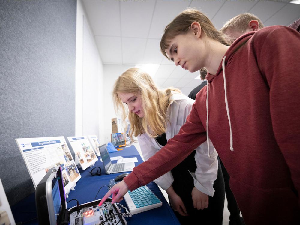 Two people looking at a computer