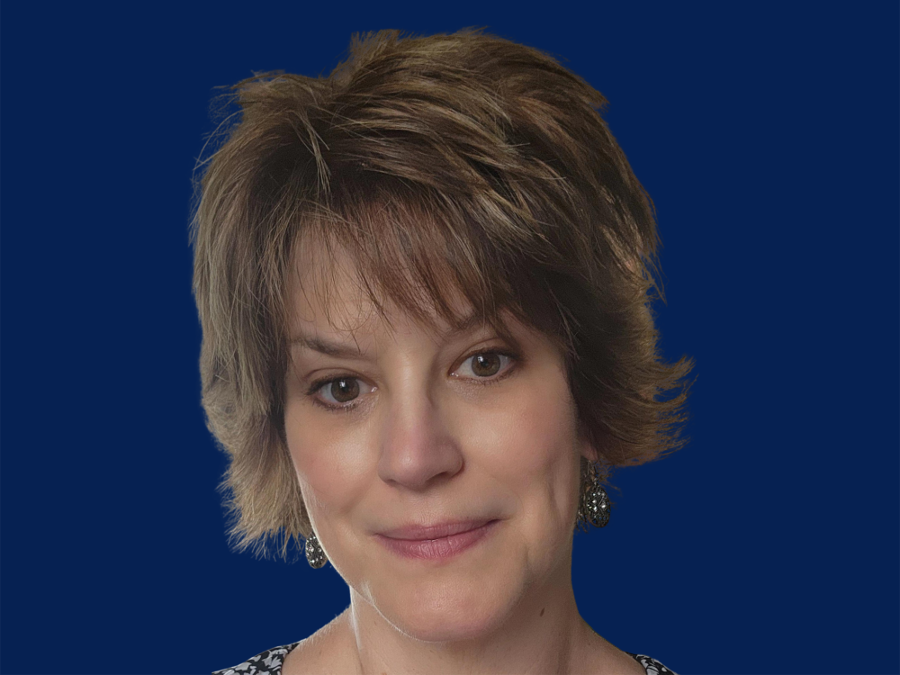 Close up photo of woman with light brown hair.