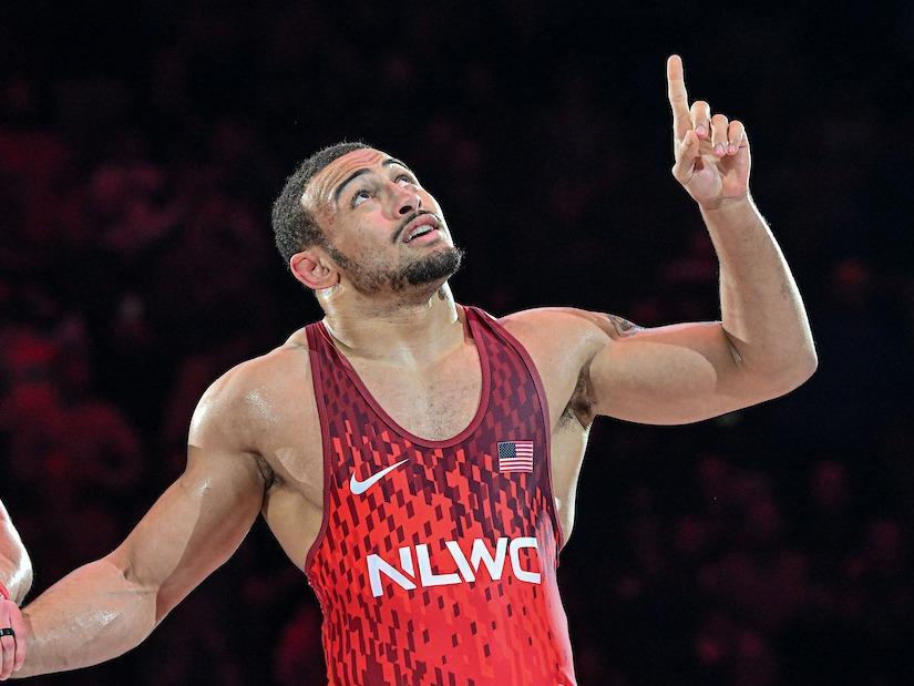 Wrestler points to sky in celebration