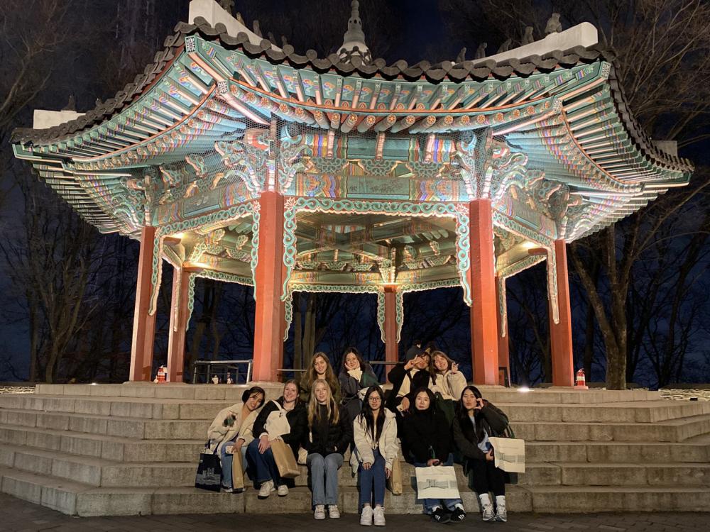 Ten KOR 497 students pose at the Namsan Tower in Seoul, South Korea.