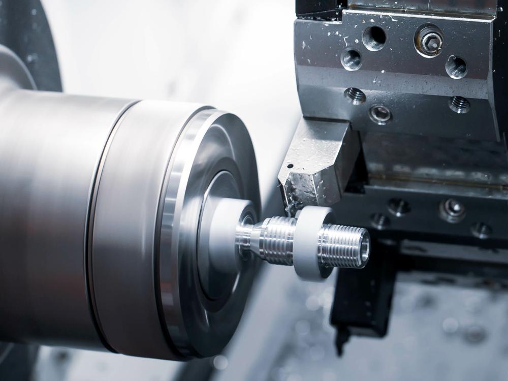 A CNC lathe machine completing a cutting process.