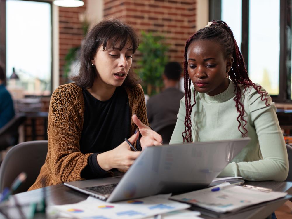 Two people looking at a laptop