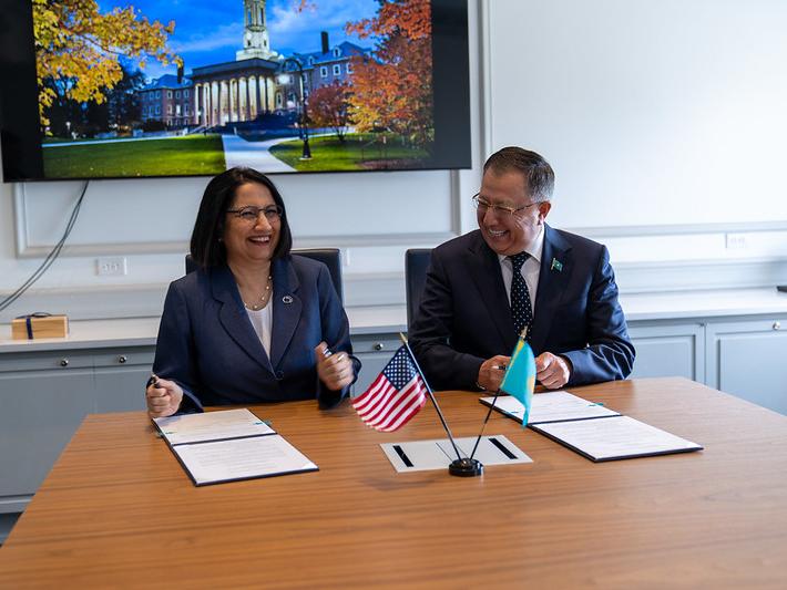 A man and a woman laughing at a table
