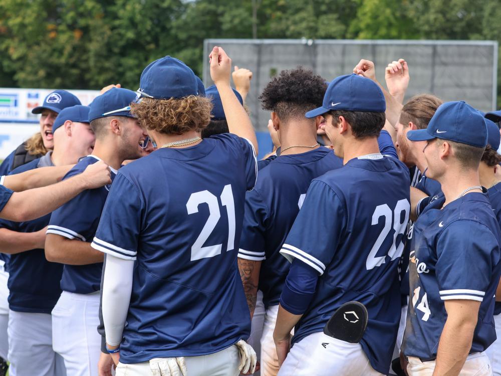 Members of a baseball team huddle together