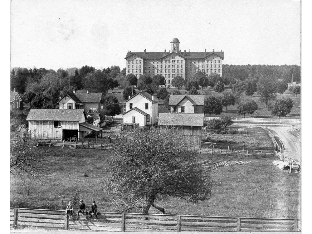 A black and white picture of a college campus taken in the 1800s