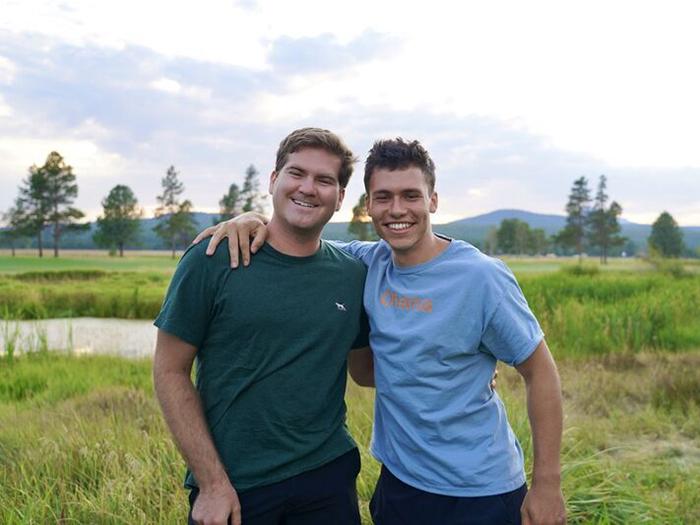 Two people standing in a field