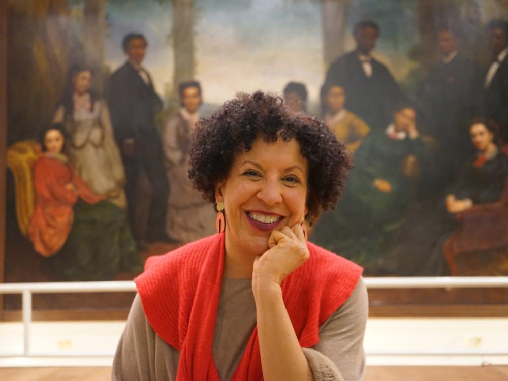 P. Gabrielle Foreman, with a large portrait of 19th-century African Americans in the background