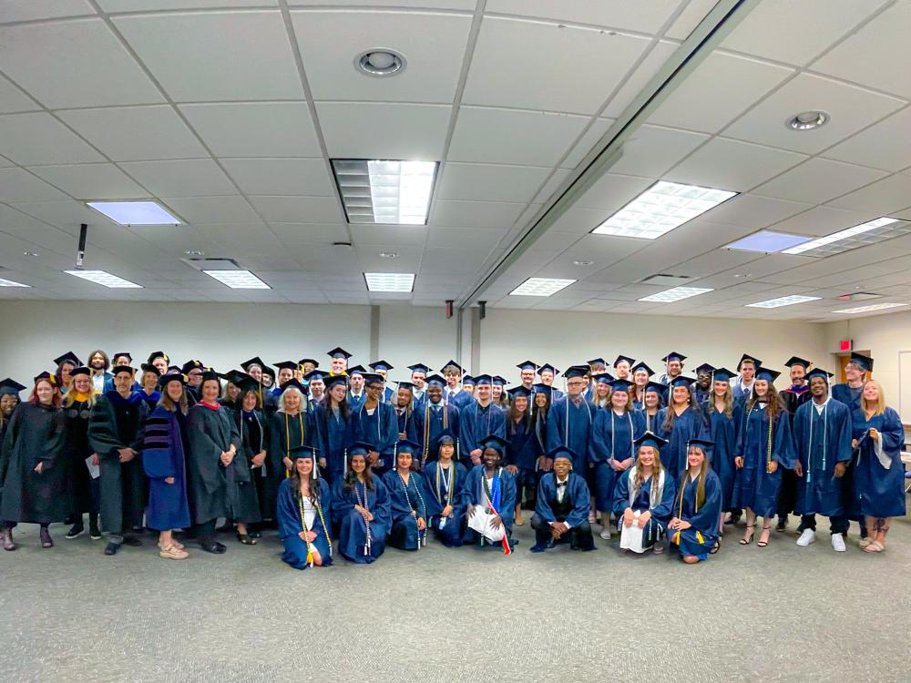 graduates and faculty in their caps and gowns