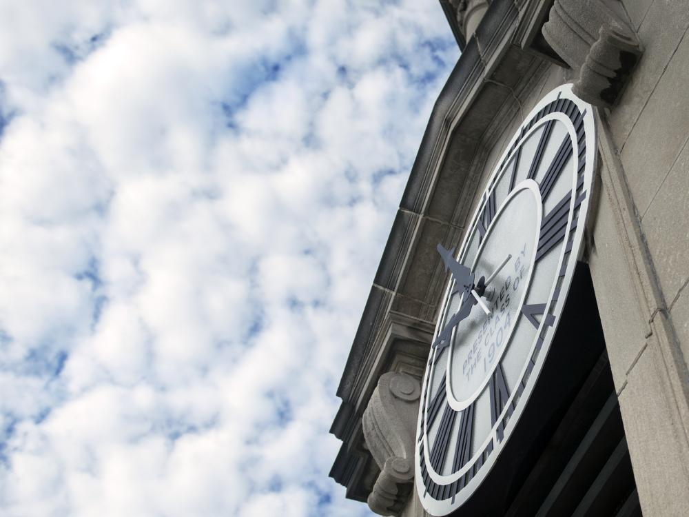 Old Main clock to the right, with clouds pictured above